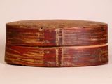 a wooden box that has been painted red and brown