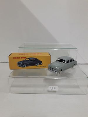 a toy car and a box on a white surface