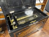 a wooden box with a musical instrument inside of it