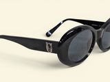 black cat eye sunglasses on a white surface with a white background