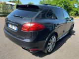 the rear end of a black mercedes suv parked in a parking lot
