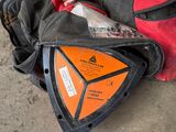 a bag with a helmet and a wrenet laying on the ground
