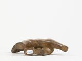 a small wooden sculpture of a dog laying on its back