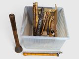 a plastic container filled with tools and a wooden spoon
