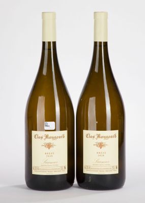 two bottles of wine sitting next to each other on a white surface