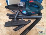 a vacuum that is sitting on the floor next to other items