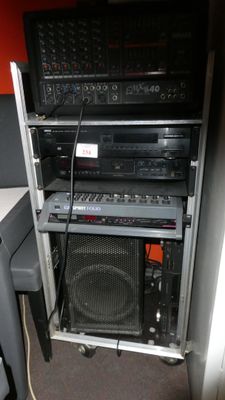 a stack of audio equipment in the corner of a room