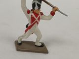 figurine of a toy soldier holding a rifle and a sword