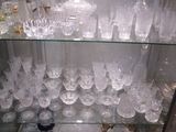 a glass display case with a lot of glasses on it