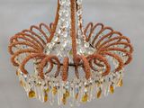 a chandelier hanging from the ceiling with crystals on it