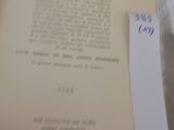 a close up of an open book with a tag on it