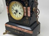 a clock that is sitting on a table next to a key