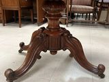 a wooden table with a marble top and a wooden base