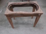 a small wooden table with a glass on it