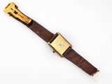 a close up of a watch on a white surface