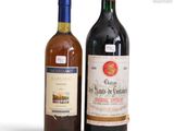 two bottles of wine sitting next to each other on a white surface