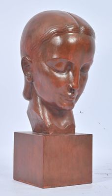 sculpture of a woman ' s head on a wooden base
