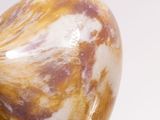 a close up of a vase on a white surface