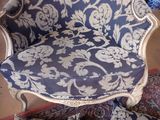 a blue and white chair that has a blue and white pattern on it