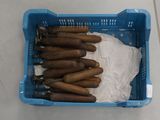 a lot of hot dogs in a basket on the floor