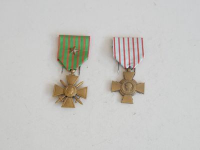 two medals are shown on a white surface with red, green and white stripes