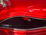 a close up of a red purse with a zipper