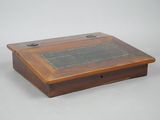 a small wooden box that has a plaque on it