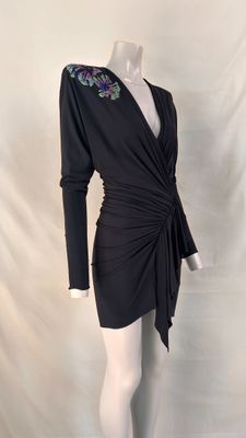 a mannequin dress with a floral design on the shoulders