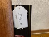 a tag hanging from a wooden pole on the floor