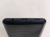 the back of a black samsung phone with the camera on it ' s side