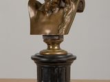 a bronze bust of a man on a pedestal