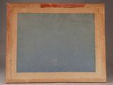 an old picture frame sitting on top of a table next to a white wall