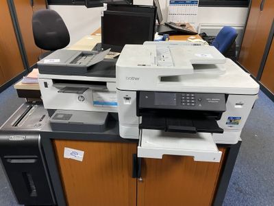 a printer sitting on top of a desk in an office