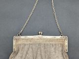 an antique silver mesh purse with chain strap and clasp