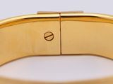 an image of a close up of a gold bracelet on a white surface