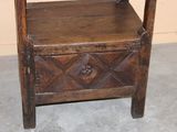 a small wooden bench with a drawer on top of it