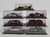 five different model cars in a display case