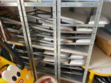 many trays of pizza on the shelves in the room