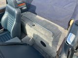 a seat in the back of a car with a blue cover on it