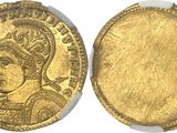 a gold coin with an image of a woman on it