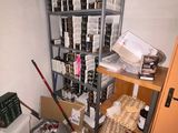a room with a shelf full of items and a toilet