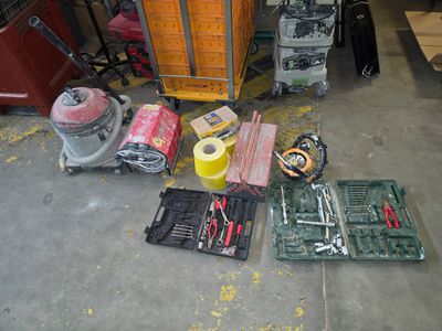 many tools that are sitting on the floor in the garage