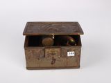 an old brass box with a lid and a key on it