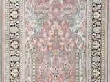 an antique persian rug with a floral design on a white background