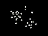 black and white photograph of a bunch of diamonds on a black surface