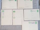 four postcards are sitting on a blue sheet of paper on a table