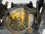 a close up of a compass on a tripod