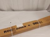 a cardboard box with a roll bar on it sitting on top of a white sheet