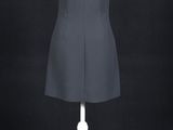 the back view of a black dress on a mannequin stand