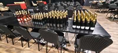 many bottles of wine sitting on a table in the middle of a room